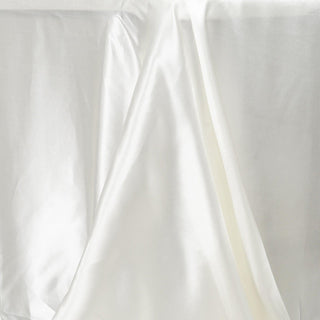 Elevate Your Event Decor with the Ivory Satin Seamless Rectangular Tablecloth