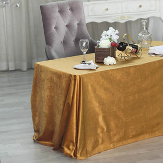 Elegant gold tablecloth draping over a table set for dining.