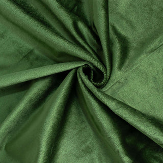 Green velvet fabric with a smooth texture and rich color.