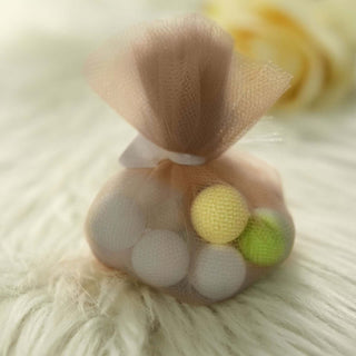 Colorful foam balls in a mesh bag on a soft surface.