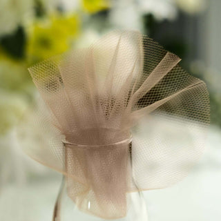Decorative tulle flower arrangement in a glass vase.