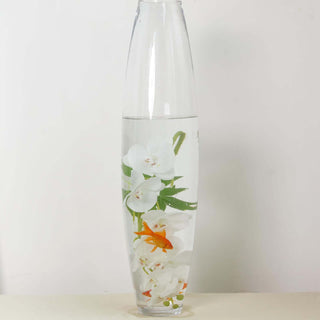 Vase with white orchids and goldfish in water