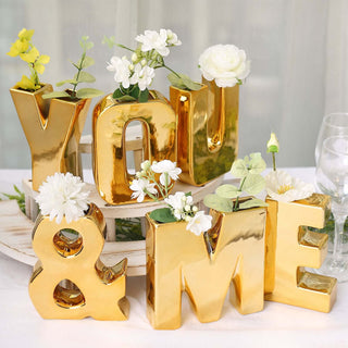 Gold decorative letters "YOU & ME" with flowers in a stylish arrangement.
