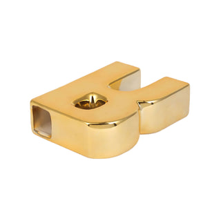 Gold letter "H" candle holder on a plain white backdrop