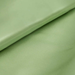 Green fabric texture with soft folds and smooth surface.
