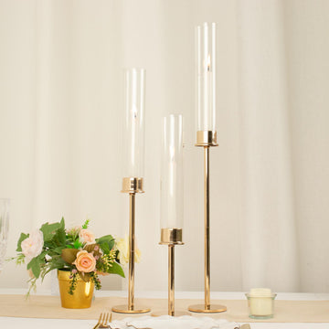 Set of 3 Gold Metal Clear Glass Hurricane Candle Stands, Taper Candlestick Holders With Glass Chimney Candle Shades - 16", 20", 24"