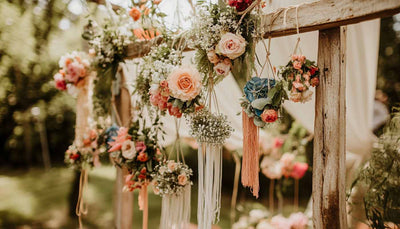 Floral hanging display with ribbons and greenery