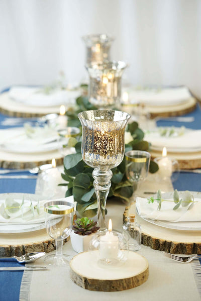 Blue and white rustic table setting with gold candleholders