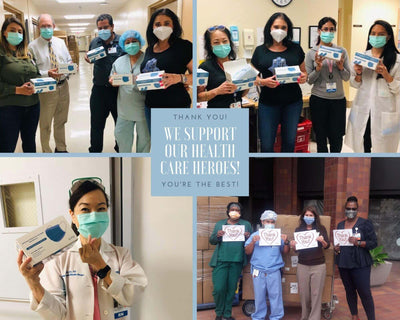 Health care workers holding donated supplies