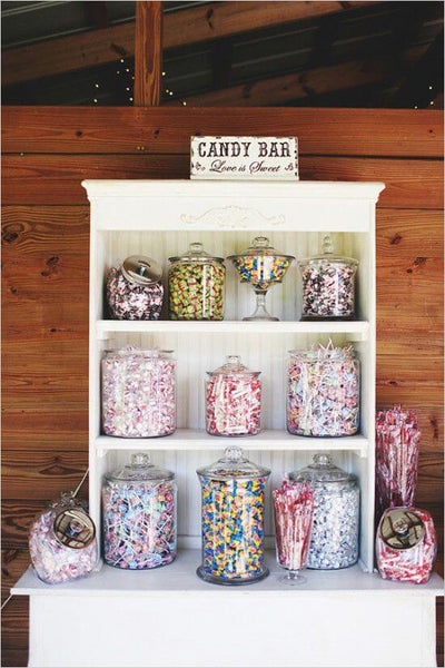 Candy buffet display with glass jars of colorful sweets