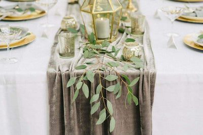 Velvet table runner with greenery and candle centerpiece