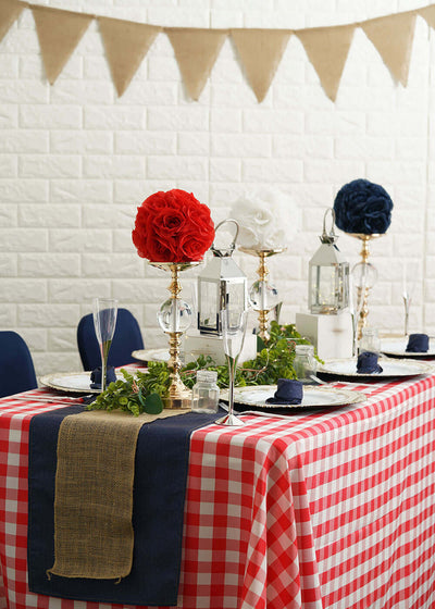 Picnic table with checkered cloth and floral centerpieces