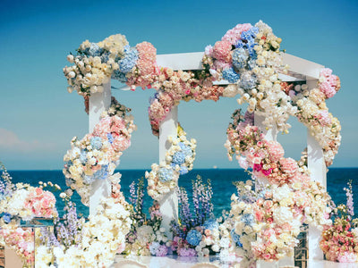 Floral wedding arch by the ocean