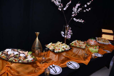 Buffet table with salads and plated dishes