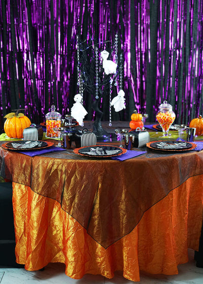 Halloween party table with pumpkins and ghost centerpiece