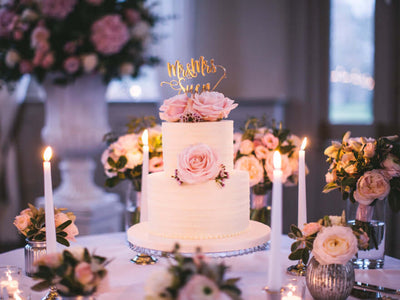Wedding cake with pink rose topper