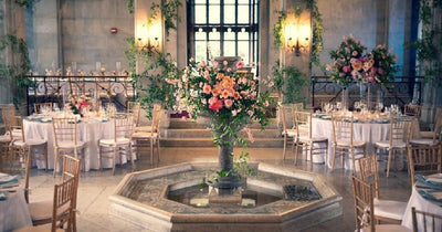 Elegant indoor wedding reception with floral centerpiece