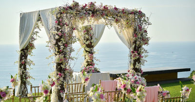 Flower-covered wedding arch by the sea