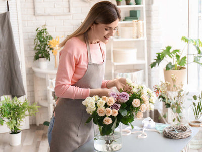 Woman arranging a bouquet of artificial roses