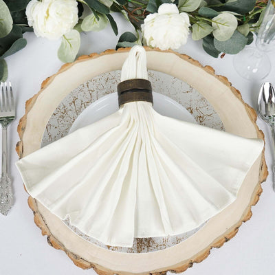 White napkin folded in a ring on a rustic place setting