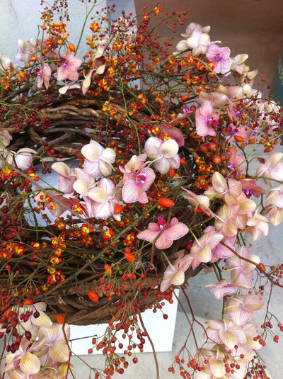 Spring wreath with pink flowers and red berries