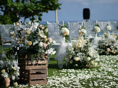 Beach wedding aisle with floral arrangements