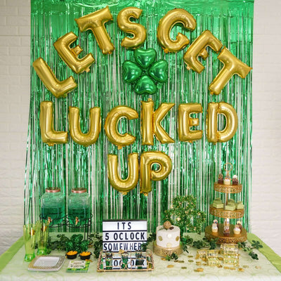 St. Patrick's Day dessert bar with gold balloons