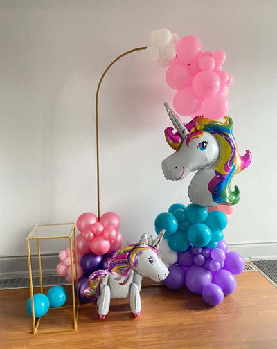 Unicorn balloon arrangement with pink, blue, and purple balloons