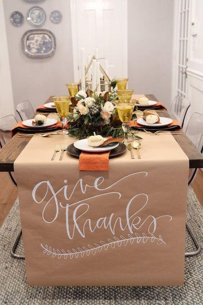 Thanksgiving table with place settings and floral centerpiece