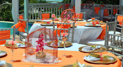 Orange-and-white pool luau tablescape