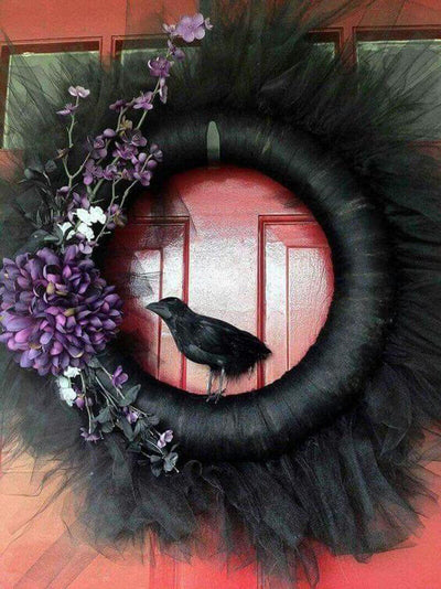 Black Halloween wreath with purple flowers and a crow