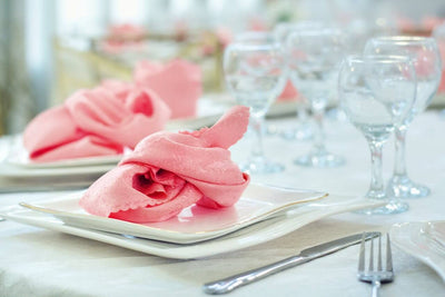 Pink napkin folded on a wedding place setting