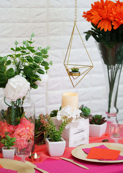 Succulent-filled summer tablescape with candles and flowers