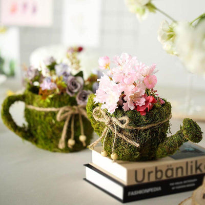 Moss teacup planter with pink flowers