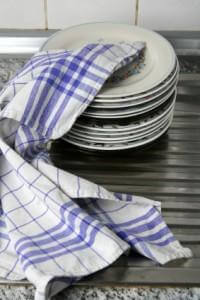 Dish stack wrapped in a plaid tablecloth