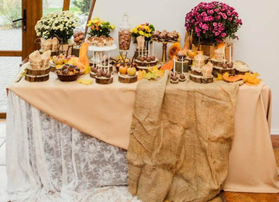 Fall tablescape with lace, burlap, and floral arrangements