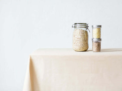 Linen tablecloth with jars on a table