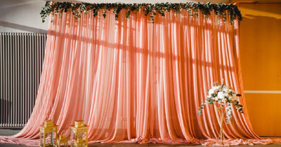 Pink draped curtains with floral garland
