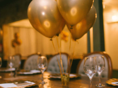 Gold balloons over a decorated party table