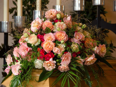 Pink and peach rose funeral arrangement