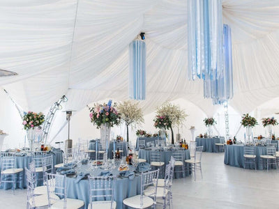 Dusty blue wedding reception in a white tent