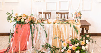 Wedding reception table with floral centerpiece and draped tablecloth