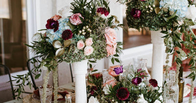 Colorful artificial flower arrangements on table stands