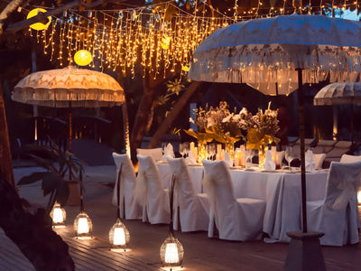 Outdoor event table with string lights and lanterns