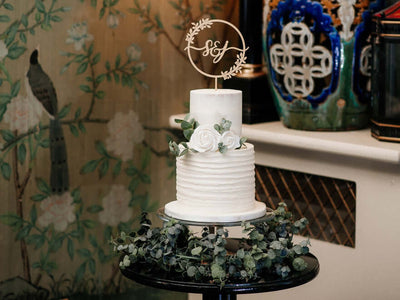 White cake with floral topper