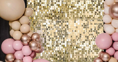 Gold sequin backdrop with pink and gold balloon garlands