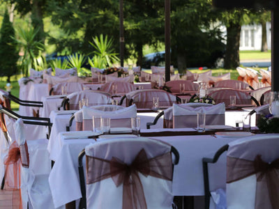 Outdoor reception tables with white linens