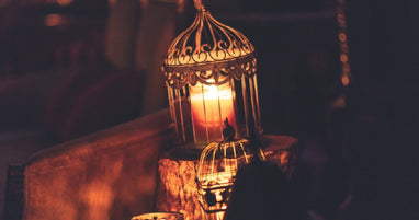Lit candle lantern on a wood block
