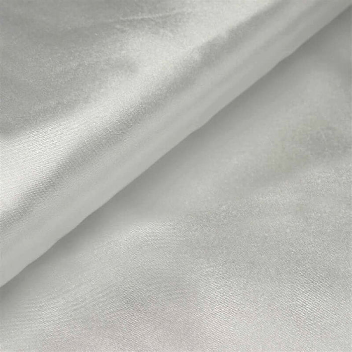 Silky white fabric draped elegantly, showcasing a smooth texture.