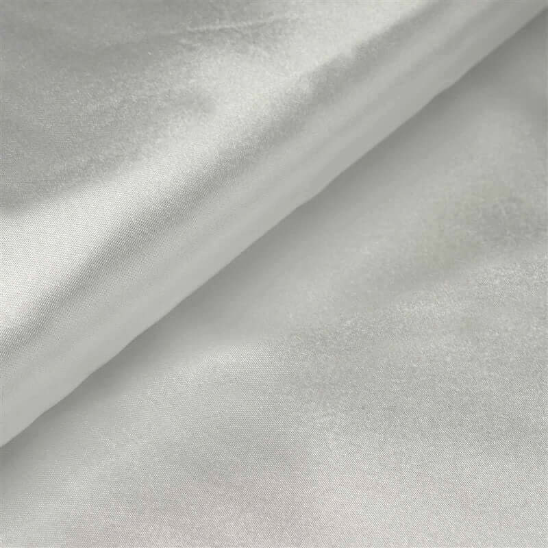 Silky white fabric draped elegantly, showcasing a smooth texture.
